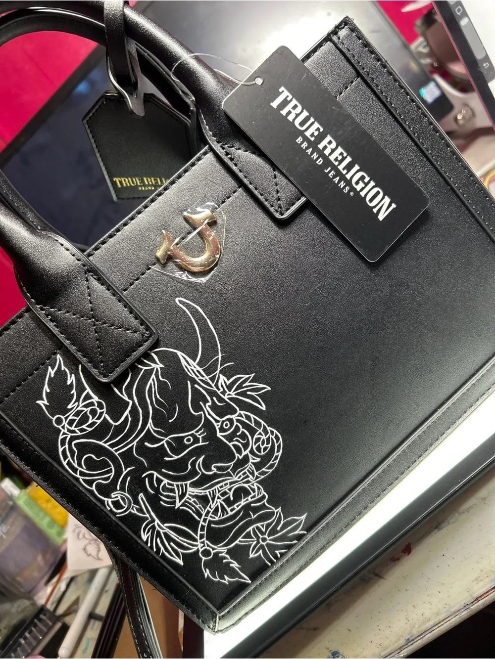 True Religion Black Satchel with White Graphic Demon Motif